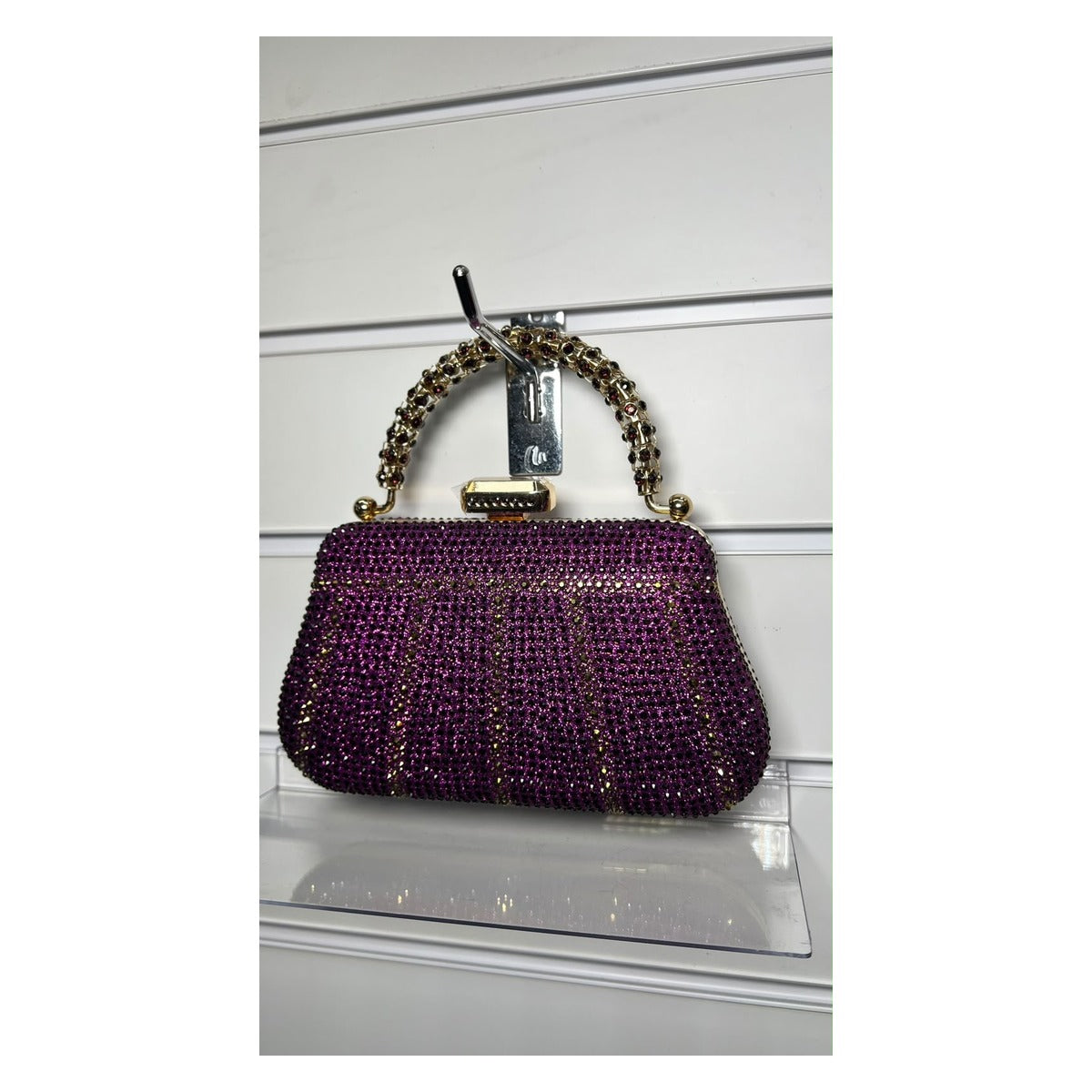 The Crystal Royale rhinestone evening clutch bag in amethyst purple with gold-tone handle