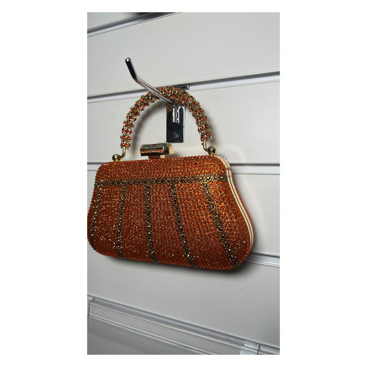 The Crystal Royale rhinestone evening clutch bag in burnt orange with gold-tone handle